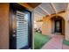 Front entry with black door and side glass door leading to a courtyard at 2149 Cedar River Ct, Henderson, NV 89044