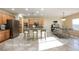Virtually staged kitchen features an island, stainless steel appliances, and light wood cabinets at 2149 Cedar River Ct, Henderson, NV 89044