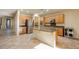 Open kitchen with island, stainless steel appliances, and light wood cabinets at 2149 Cedar River Ct, Henderson, NV 89044