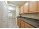 Kitchen features dark countertops and light wood cabinets at 2149 Cedar River Ct, Henderson, NV 89044