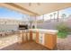 Outdoor kitchen with built-in grill and refrigerator at 2149 Cedar River Ct, Henderson, NV 89044