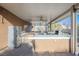 Outdoor kitchen with stainless steel appliances and ceiling fan at 2149 Cedar River Ct, Henderson, NV 89044