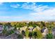 Expansive view of rooftop homes, palm trees, and a lush green landscape in a vibrant neighborhood setting at 3111 Bel Air Dr # 7F, Las Vegas, NV 89109