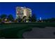 Luxury high-rise building and golf course view featuring lush greens, tall trees, and the city skyline at dusk at 3111 Bel Air Dr # 7F, Las Vegas, NV 89109