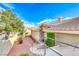 Tan stucco home with tile roof, walkway, and landscaping at 3262 Mystic Ridge Ct, Las Vegas, NV 89129