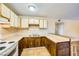 U-shaped kitchen featuring wood cabinets and white appliances at 376 N 15Th St, Las Vegas, NV 89101