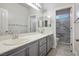 Bathroom with double vanity and marble shower at 4119 Amberdale Ave, North Las Vegas, NV 89031