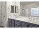 Bathroom with double vanity, shower, and updated fixtures at 4119 Amberdale Ave, North Las Vegas, NV 89031