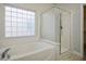 Bathroom features a bathtub, shower, and updated flooring at 4119 Amberdale Ave, North Las Vegas, NV 89031