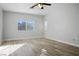 Bright bedroom with hardwood floors, ceiling fan, and large window at 4119 Amberdale Ave, North Las Vegas, NV 89031