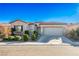 Single story home with landscaped yard and two car garage at 4119 Amberdale Ave, North Las Vegas, NV 89031