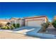 Single story home with landscaped yard and two car garage at 4119 Amberdale Ave, North Las Vegas, NV 89031