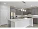 A large kitchen island with pendant lighting and stainless steel appliances is a focal point at 4119 Amberdale Ave, North Las Vegas, NV 89031