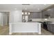 This large kitchen includes an island, stainless appliances, and gray cabinets at 4119 Amberdale Ave, North Las Vegas, NV 89031