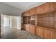 Spacious living room featuring custom built-in shelving and cabinet space with gray walls at 4123 Redfield Ave, North Las Vegas, NV 89032