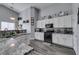 Modern kitchen featuring granite countertops and white cabinetry at 4624 Mission Cantina St, North Las Vegas, NV 89081