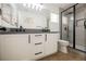 Bathroom with double vanity, gray countertops, and a frameless shower at 5420 Tinker Toy Ave, Las Vegas, NV 89139