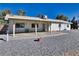 Backyard view showcasing the covered patio, desert landscaping, and peaceful surroundings at 561 Jarvis Rd, Pahrump, NV 89060