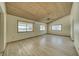 Spacious living room featuring laminated floors, ceiling fan, and natural light at 561 Jarvis Rd, Pahrump, NV 89060