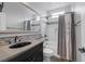 Classic bathroom featuring a large tub-shower combo with gray accents and a vanity at 5625 Galivan Vista St, North Las Vegas, NV 89081