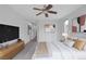 Bedroom with modern decor, including a king bed, TV, and neutral color palette at 5625 Galivan Vista St, North Las Vegas, NV 89081