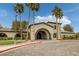 Elegant clubhouse featuring classic architecture, lush landscaping, and ample parking at 5625 Galivan Vista St, North Las Vegas, NV 89081