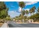 Elegant community entrance with mature palm trees and lush landscaping at 5625 Galivan Vista St, North Las Vegas, NV 89081