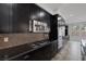 Gourmet kitchen features dark cabinets, stainless steel appliances, and granite countertops at 5625 Galivan Vista St, North Las Vegas, NV 89081
