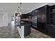 Open kitchen layout with dark cabinets, granite countertops, and stainless steel appliances at 5625 Galivan Vista St, North Las Vegas, NV 89081