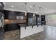 Modern kitchen featuring sleek black cabinets, stainless steel appliances, and granite countertops at 5625 Galivan Vista St, North Las Vegas, NV 89081