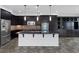 Modern kitchen with dark cabinets, granite countertops, and stainless-steel appliances at 5625 Galivan Vista St, North Las Vegas, NV 89081