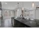 Kitchen island with granite countertop, stainless steel dishwasher and dual sinks at 5625 Galivan Vista St, North Las Vegas, NV 89081