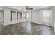 Spacious living room with natural light from multiple windows and modern ceiling fan at 5625 Galivan Vista St, North Las Vegas, NV 89081