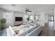 Open living space with large windows, a comfortable sectional sofa, and stylish decor at 5625 Galivan Vista St, North Las Vegas, NV 89081