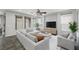 Bright living room with large windows, a comfortable sectional sofa, and stylish decor at 5625 Galivan Vista St, North Las Vegas, NV 89081