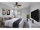 Stylishly staged main bedroom with large bed, modern decor, and light-filled windows at 5625 Galivan Vista St, North Las Vegas, NV 89081
