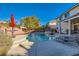 Inviting backyard oasis featuring a sparkling pool, patio furniture, and a covered patio at 6250 Pale Pavilion Ave, Las Vegas, NV 89139