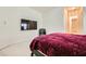 Bedroom with a large bed, sitting chair, and large TV at 6250 Pale Pavilion Ave, Las Vegas, NV 89139