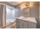 Updated bathroom with gray vanity, marble tile, and bathtub at 635 8Th St, Boulder City, NV 89005