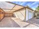 Covered carport with brick pavers and wooden gate at 635 8Th St, Boulder City, NV 89005