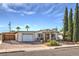 Single story home with carport, landscaping, and large trees at 635 8Th St, Boulder City, NV 89005