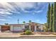 Single story home with carport, landscaping, and large trees at 635 8Th St, Boulder City, NV 89005