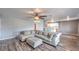 Open living room with L-shaped sofa and wood-look floors at 635 8Th St, Boulder City, NV 89005