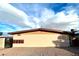 Front view of a beige building with a brown roof and gated entrance at 720 N 10Th St, Las Vegas, NV 89101