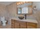 Bathroom featuring granite countertops, a vessel sink, and a vanity mirror with lighting at 7220 Stormson Dr, Las Vegas, NV 89145