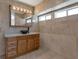 Updated bathroom with new vanity, vessel sink, and tiled walls at 7220 Stormson Dr, Las Vegas, NV 89145