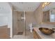 Bathroom with walk-in shower, toilet, and modern vanity at 7220 Stormson Dr, Las Vegas, NV 89145