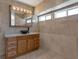 Bathroom featuring granite countertops, a vessel sink, and three small windows at 7220 Stormson Dr, Las Vegas, NV 89145