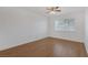 Simple bedroom with hardwood floors and large window at 7220 Stormson Dr, Las Vegas, NV 89145