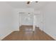 Well-lit bedroom featuring mirrored closet doors and wood-look flooring at 7220 Stormson Dr, Las Vegas, NV 89145